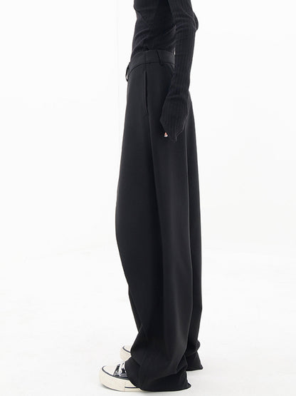 Pantalons larges à jambes asymétriques avec boutons